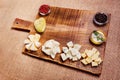 Cheese platter garnished on rustic wooden board Royalty Free Stock Photo