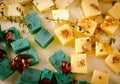 Cheese platter, Gouda, feta, blue pesto cheeses on white plate with herbs, olive oil, pomegranate and mustard sauces Royalty Free Stock Photo