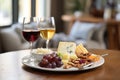 cheese platter with grapes, nuts, and a glass of red wine Royalty Free Stock Photo
