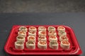 cheese platter. Mazzarella cheese with different spices. Cheese snacks of different taste in a plastic container or tray