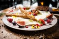 Cheese platter for two: Goat cheese cream, gorgonzola, camembert, grissini and fig jam. Delicious healthy Italian Royalty Free Stock Photo