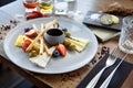 Cheese platter for two: Goat cheese cream, gorgonzola, camembert, grissini and fig jam. Delicious healthy Italian Royalty Free Stock Photo