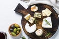 Cheese platter on white table.