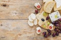 cheese platters with grapes bread wooden desk. High quality photo Royalty Free Stock Photo