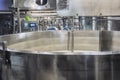 Cheese production in a cheese dairy. Whey mixing bowl. Close-up