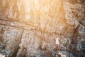 Cheese rocks from quartzite sandstone on Balck Sea in Crimea. Tourist girl in mountains Royalty Free Stock Photo