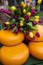 Cheese rounds decorated with tulips on street in Amsterdam, Netherlands.