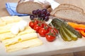 Cheese snack with german bread, mozzarella, cherry tomatoes, cucumber, grapes Royalty Free Stock Photo