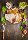 Cheese snack Gorgonzola and Camembert with wine glass honey knife cheese grapes on a branch with leaves Peaches on wooden rustic
