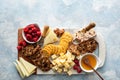 Cheese and snacks board with raspberry and crackers Royalty Free Stock Photo