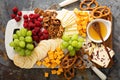 Cheese and snacks platter with honey and fresh fruit