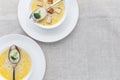 Cheese soup with broccoli in a white plate on a white linen tablecloth Royalty Free Stock Photo