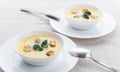 Cheese soup with broccoli in a white plate on a white linen tablecloth Royalty Free Stock Photo
