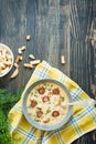 Cheese soup with grilled sausages and herbs. Cream soup served in a plate. Dark wooden background. Space for text Royalty Free Stock Photo