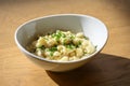 Cheese spaetzle or in austria kaesspatzn in white bowl with green chive bowl