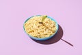 Cheese spaghetti bowl isolated on a purple background. Pasta cacio e pepe