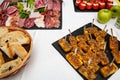 Cheese sticks. Food tray with delicious salami, pieces of sliced ham, sausage, salad. Bread. Tomatoes stuffed with cheese and garl Royalty Free Stock Photo