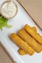 Cheese sticks fried in breadcrumbs. Mozzarella cheese sticks on a plate with sauce and lettuce Royalty Free Stock Photo