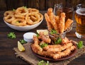 Cheese sticks and onion rings in batter with sauce. Beer snacks. Royalty Free Stock Photo