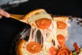 Cheese stringy slice lifted of full supreme pizza margarita baked fresh out of the oven Royalty Free Stock Photo