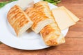 Cheese-stuffed flaky pastry sticks and different cheese close-up