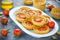 Cheese tomato tartlets , mini-pizzas with cheese and cherry tomatoes Royalty Free Stock Photo