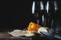 Cheese two glasses of wine on a wooden background space for copy