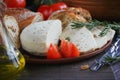 Cheese, vegetables, herbs, olive oil and bread Royalty Free Stock Photo