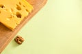 Cheese with wallnuts on a board. Cheese with nuts and copyspace