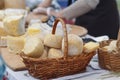 Cheese in a wicker basket on the market counter Royalty Free Stock Photo