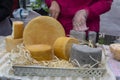 Cheese in a wicker basket on the market counter Royalty Free Stock Photo