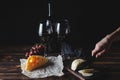 Cheese wine and bunches of grapes on a black background Royalty Free Stock Photo