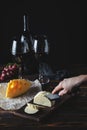 Cheese wine and bunches of grapes on a black background Royalty Free Stock Photo