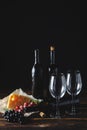 Cheese wine and bunches of grapes on a black background Royalty Free Stock Photo