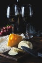 Cheese wine and bunches of grapes on a black background Royalty Free Stock Photo