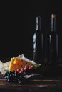 Cheese wine and bunches of grapes on a black background Royalty Free Stock Photo
