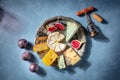 Cheese and wine. A cheeseboard with Brie, blue cheese and other sorts Royalty Free Stock Photo