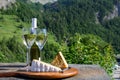 Cheese and wine, glasses of dry white Roussette de Savoie and Vin de Savoie wine from Savoy region, tomme and blue cheese, view on Royalty Free Stock Photo