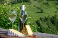 Cheese and wine, glasses of dry white Roussette de Savoie and Vin de Savoie wine from Savoy region, tomme and blue cheese, view on Royalty Free Stock Photo