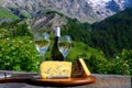 Cheese and wine, glasses of dry white Roussette de Savoie and Vin de Savoie wine from Savoy region, tomme and blue cheese, view on Royalty Free Stock Photo