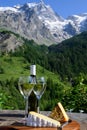 Cheese and wine, glasses of dry white Roussette de Savoie and Vin de Savoie wine from Savoy region with tomme cheese and view on Royalty Free Stock Photo