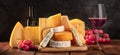 Cheese and wine panorama on a black background. Many different cheeses Royalty Free Stock Photo