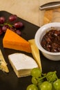 Cheeseboard platter with grapes and pickle and crackers