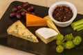 Cheeseboard platter with grapes and pickle Royalty Free Stock Photo