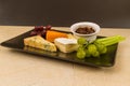 Cheeseboard platter with grapes and pickle Royalty Free Stock Photo