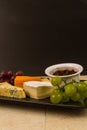 Cheeseboard platter with grapes and pickle