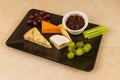 Cheeseboard platter with grapes and pickle