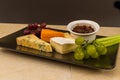 Cheeseboard platter with grapes and pickle Royalty Free Stock Photo