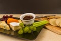 Cheeseboard platter with grapes and pickle and crackers