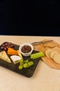 Cheeseboard platter with grapes and pickle and crackers Royalty Free Stock Photo